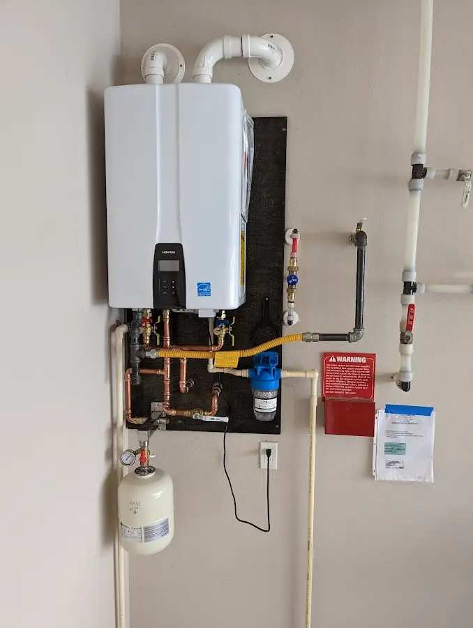 Professional plumber installing copper piping in a North St. Paul home